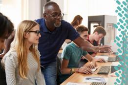 Teacher leaning over a student