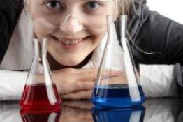 Student looking through conical flasks